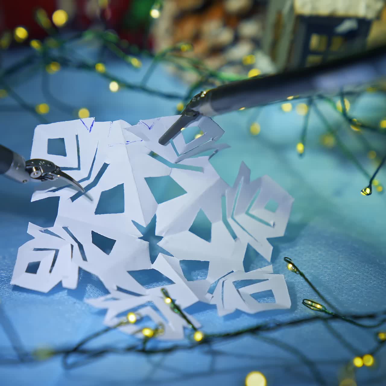 Super presice robotic equipment used for decorating process. Exquisite robotic arms deal with paper snowflake close up. Christmas decoration at the backdrop