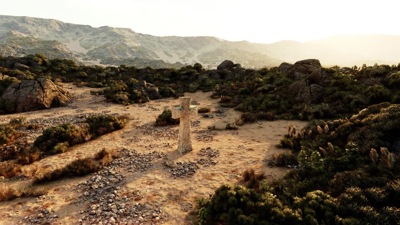 cruz de piedra en un paisaje desértico al atardecer