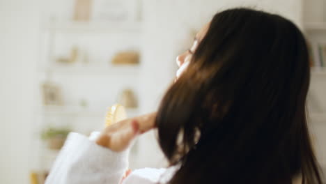 Woman Singing in Bathrobe with a Brush