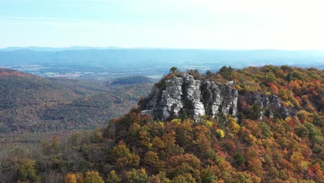 an aerial shot of big schloss, a rock formation on great north mountain, the border between virginia and west virginia in the autumn