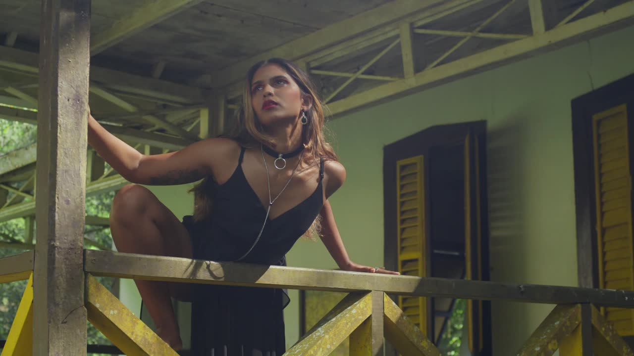 A young girl wearing a black dress exploring a historical complex.
