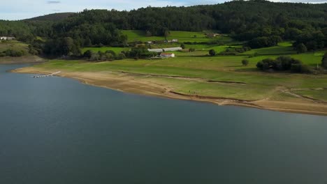 People-On-The-Shore-Of-Embalse-de-Portodemouros,-Reservoir-In-La-Coruna,-Spain