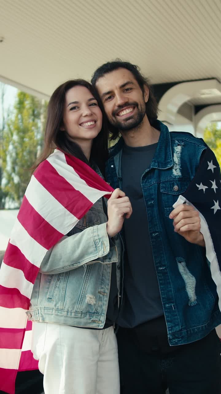 Couple Smiling Proudly with American Flag