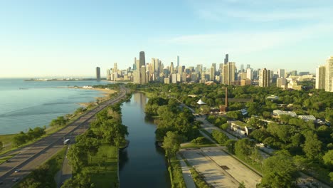 aerial, pan left to reveal lincoln park and lake michigan with chicago skyline in background