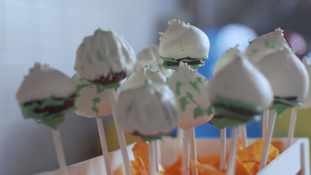 primer plano de un montón de cake pops decorados en un soporte de madera 120fps