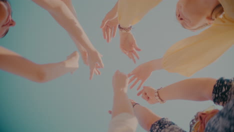 hands of young women and men dancing on sunny day