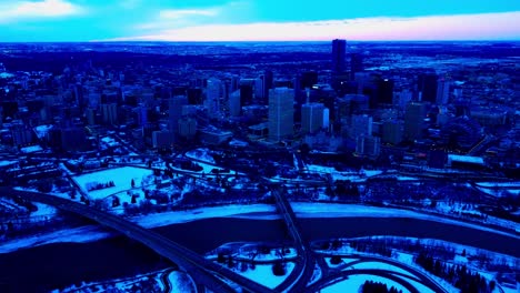 4k twilight winter snow aerial pan out downtown edmonton southeast valley edge overlooking north saskatchewan river reflection of cars crossing the low level scona and connors rd 98 ave bridges 2-2