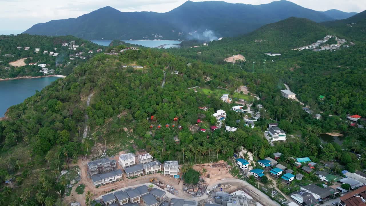 Aerial view of Koh Phangan’s coastline, highlighting turquoise waters, beaches, and lush tropical landscapes