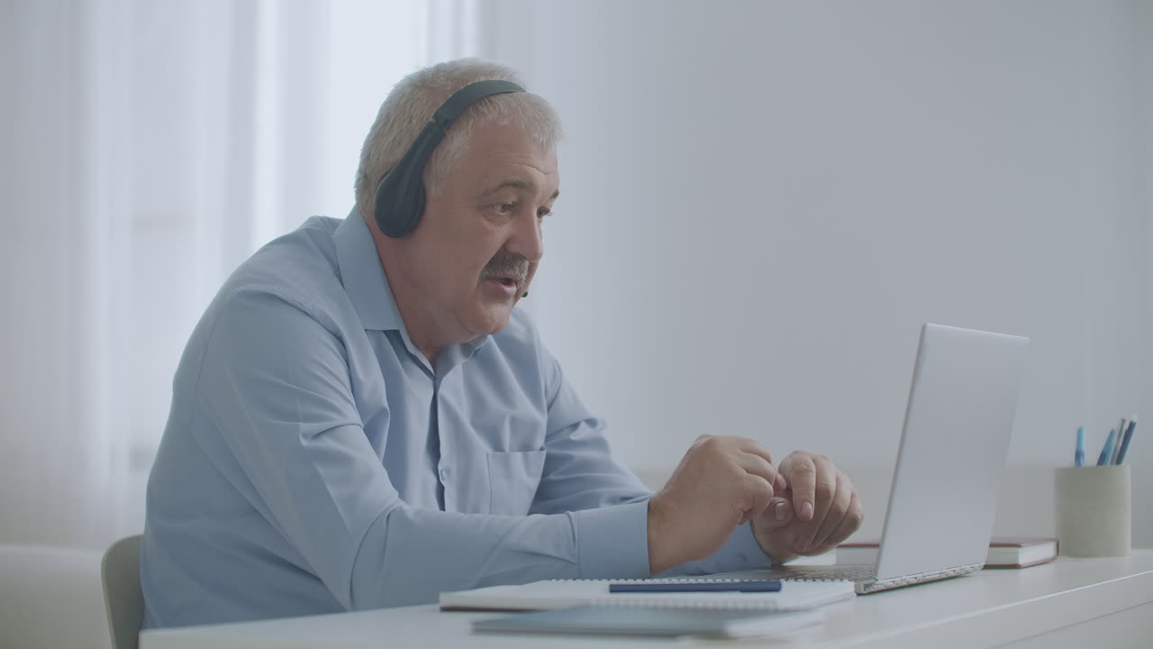 middle-aged man is talking by video chat with colleagues working remotely connecting with departments
