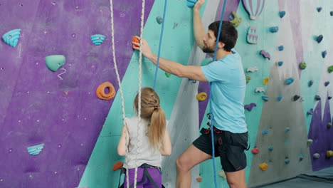 father and daughter rock climbing lesson
