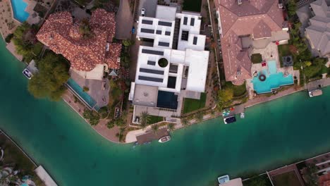 aerial view of luxury waterfront homes and community with canal