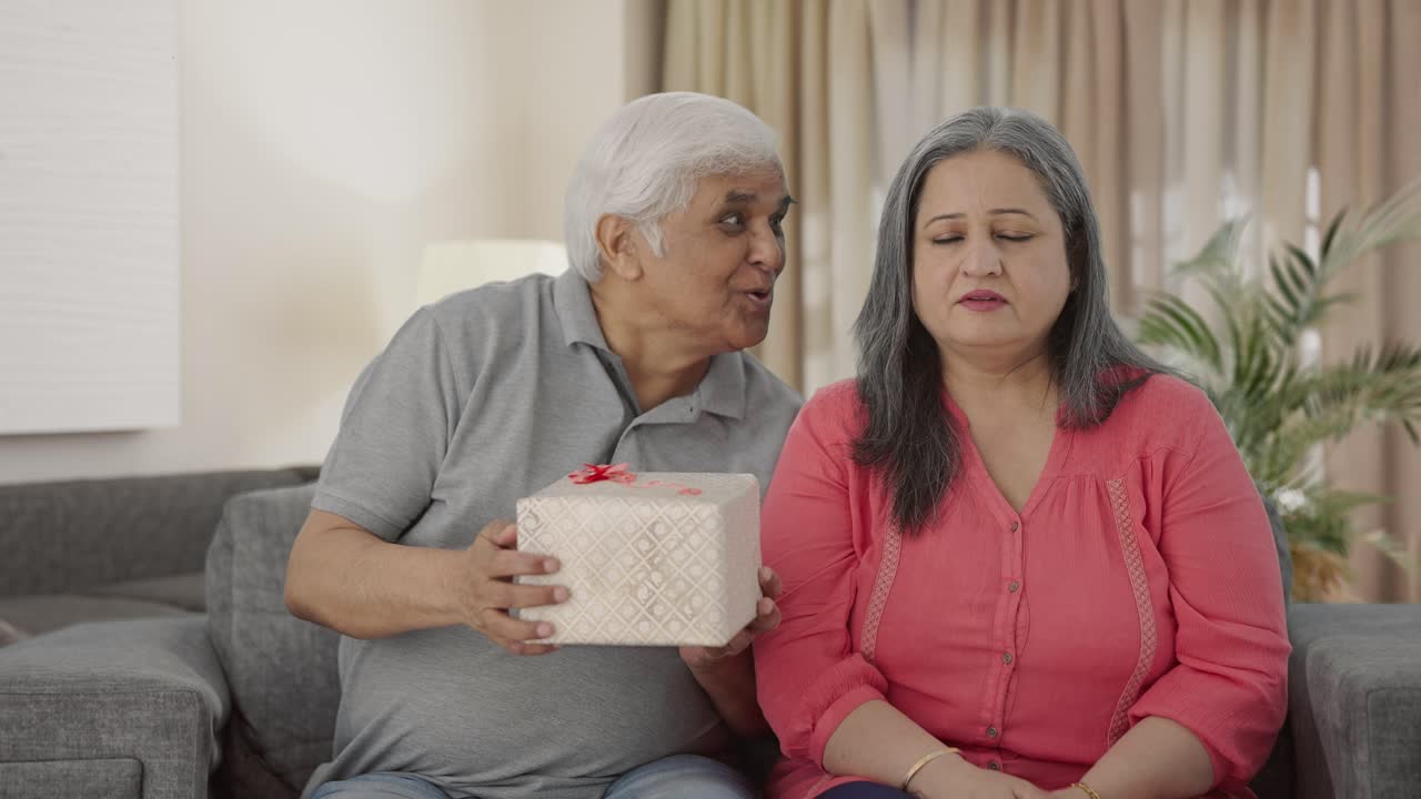 el viejo marido indio sorprende a su esposa con un regalo.