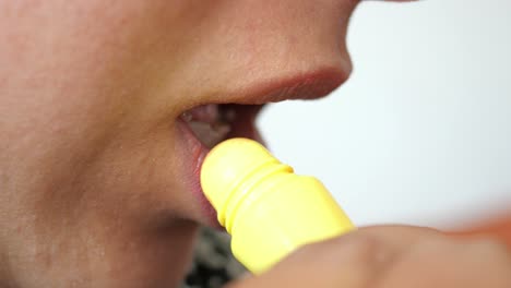 applying yellow lip balm