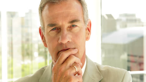 thinking businessman looking at camera