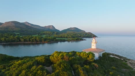 sunlight spreads across green lush island with alcanada lighthouse