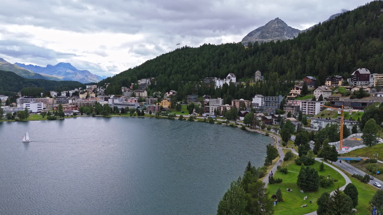 Serene lake view in St. Moritz, surrounded by lush mountains