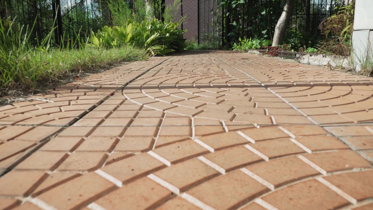 Low Angle View of a Tiled Garden Pathway on a Sunny Day
