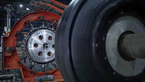 Manufacturing-rubber-tyre-blank-process-tape-spinning-on-modern-automat-closeup