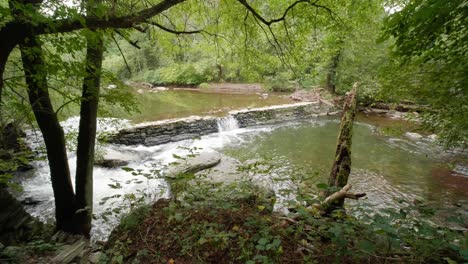 Waterfall-near-Covered-Bridge,-Thomas-Mill-at-the-Wissahickon-Creek