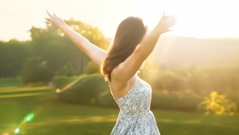 woman in a white dress enjoying the sunset