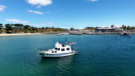 gliding past anchored boat near port