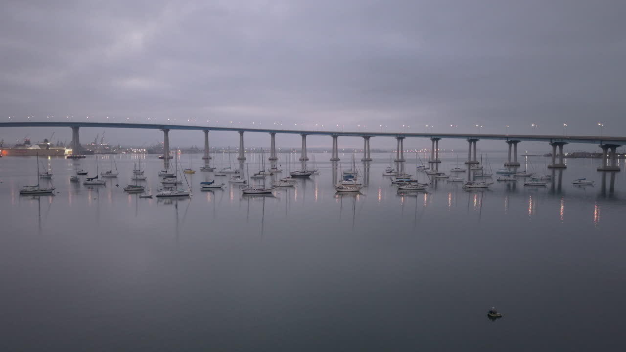 The Coronado Bridge in San Diego spanning the bay, early morning drone shot in 4k. Slow drone ascending shot