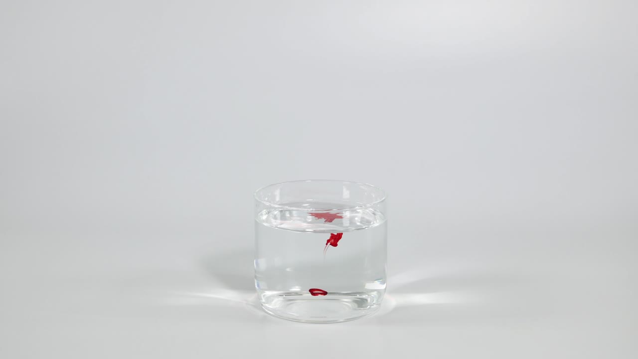 물 한 잔 에 뿌려진 은 염료 의 물방울