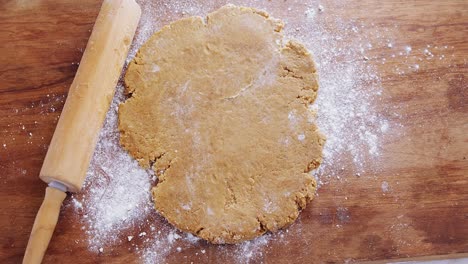 flattened dough on a wooden table 4k