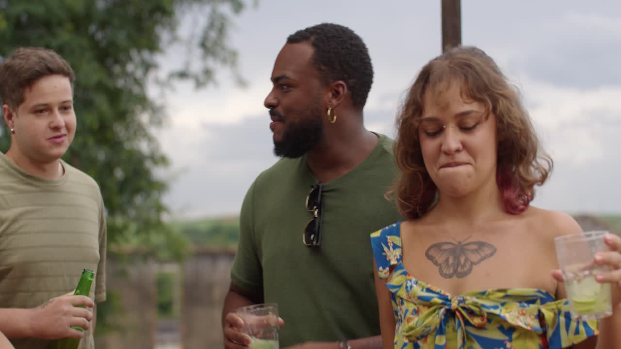 Diverse Group of Friends Socializing and Enjoying Drinks Outdoors