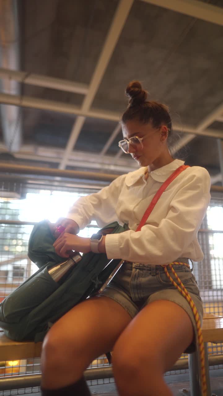 Woman with Backpack Sitting on Bench