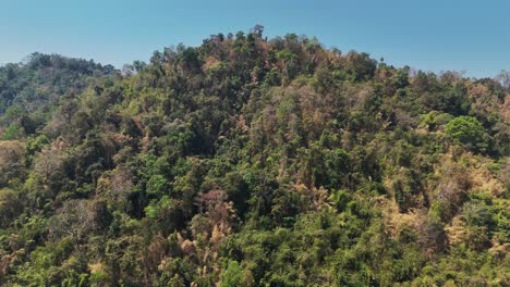 Green-mountains-in-Khoe-Laem-National-Park-in-Songklaburi,-Thailand,-with-a-lake-in-the-background