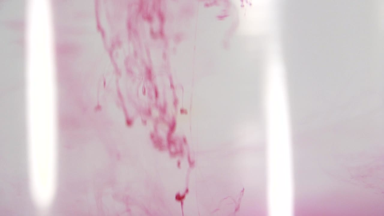 Red paint dissolving in water shot in slow motion with Sony a7iii.