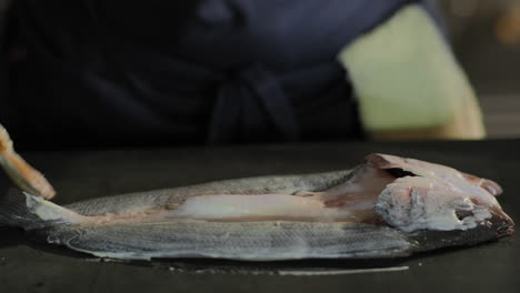 brushing aioli onto a whole fish in slow motion