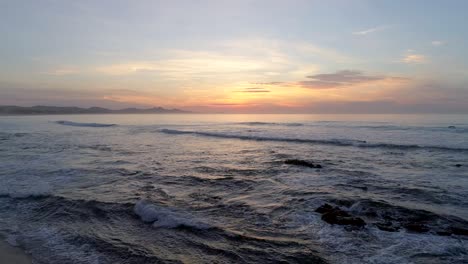 extended aerial flyover of the ocean at sunrise - lost in tranquil thought