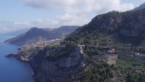 Wide-shot-of-Torre-de-Verger-in-Banyalbufar-Touristic-Town-in-Mallorca,-aerial