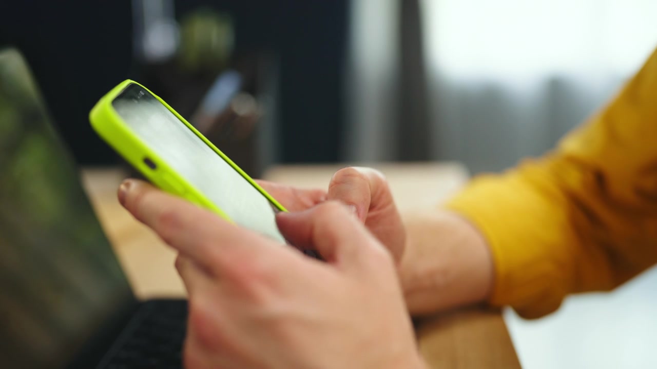 Man Using Smartphone in Bright Office Setting