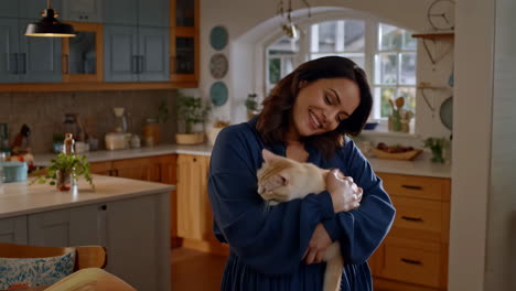 woman happily cuddling her cats