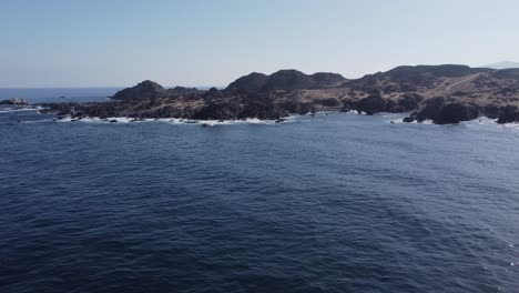 ocean aerial rotates to rocky desert coastline of rugged central chile