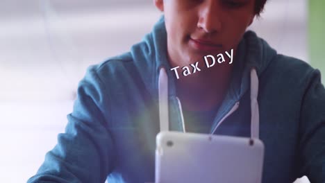 Animation-of-tax-day-text-over-boy-using-tablet