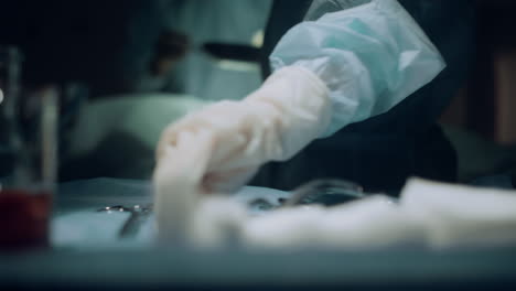 closeup surgeon operating hands in ward. unknown nurse give medical instruments.