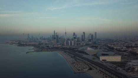 panoramic view of kuwait city skyline from the waterfront. slow descending dolly shot