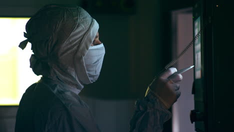 pharmaceutical worker operating production line. worker using touch screen panel