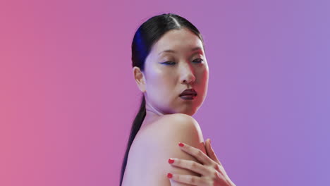 asian woman with black hair and make up looking at camera, copy space, slow motion