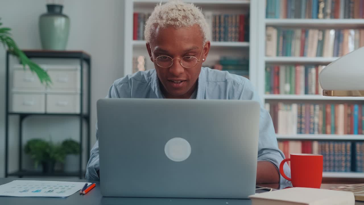 Young african american man freelancer with enthusiasm working on laptop