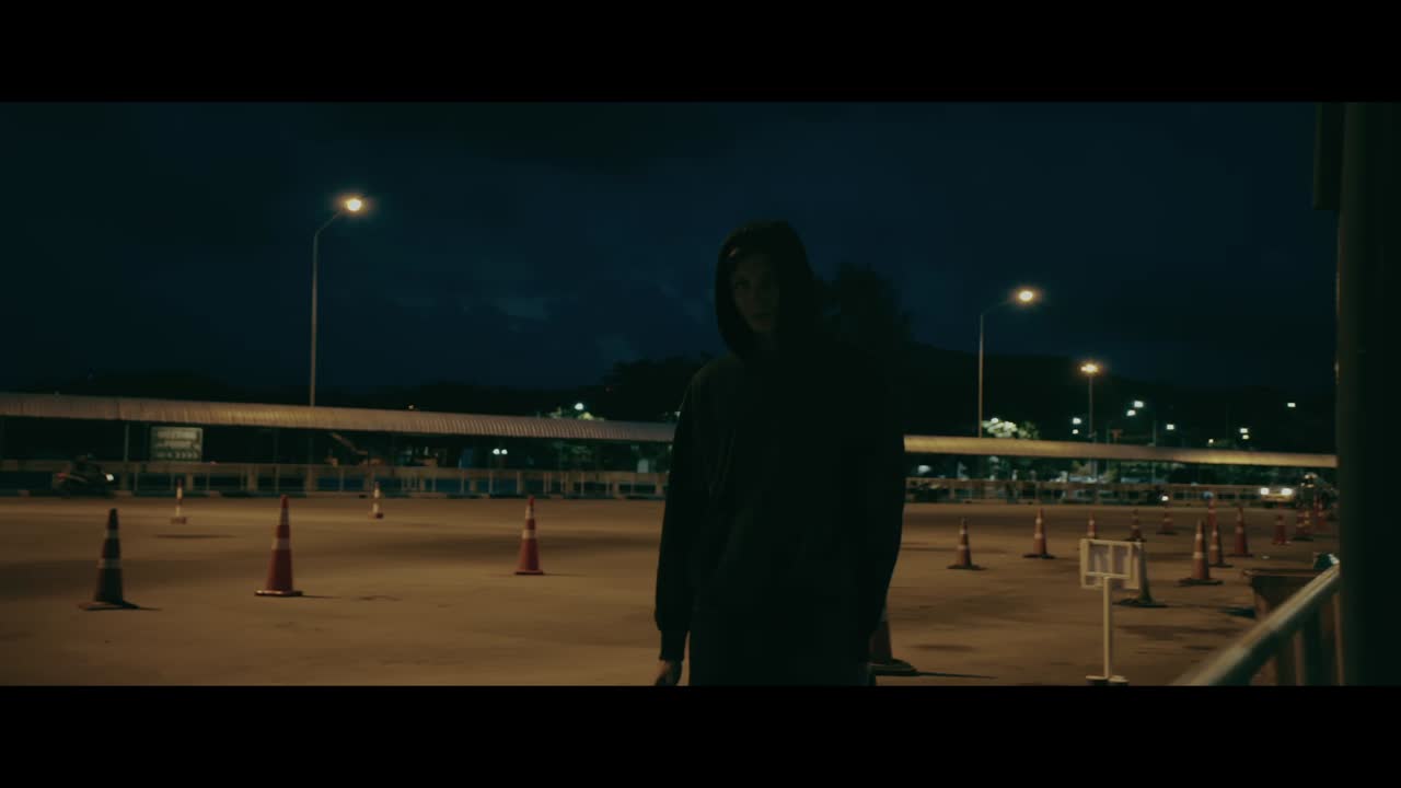 Person walking at night in a parking lot