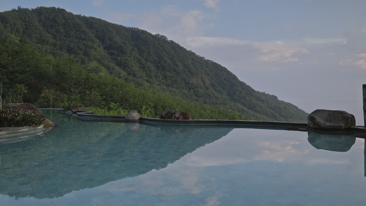 luxury swimming pool set in lush countryside of palm trees