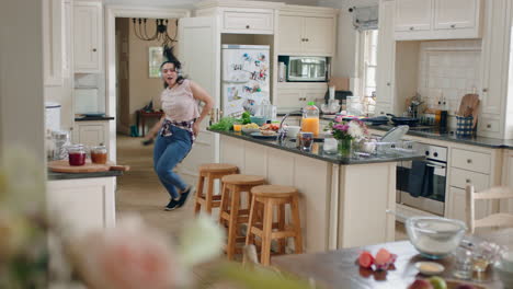 happy overweight teenage girl dancing in kitchen having fun celebrating weekend performing funny dance moves listening to music wearing headphones