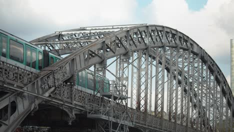 train passing in austerlitz viaduct, single-deck steel arch bridge in paris, france