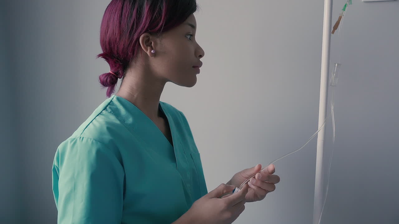 A Young American Sanitary Professional Checks The Serum Via
