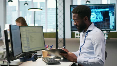 admin in tech startup office using pc, compiling software patches to fix bugs